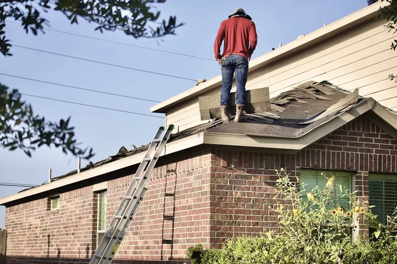 Professional roofer working on a residential roof in Geiger Heights